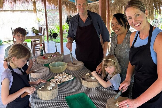 Family cooking together at an outdoor kitchen in Ubud