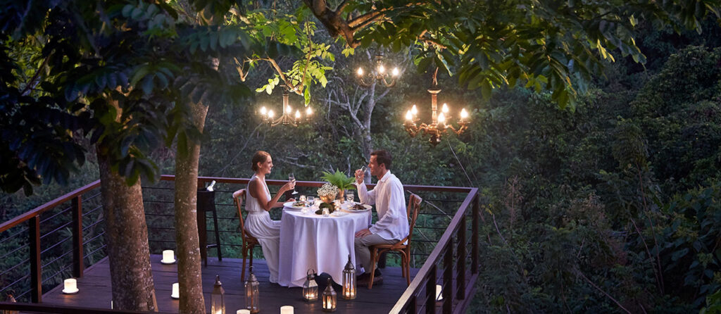 Kamandalu Ubud jungle resort with lantern-lit dining tables.